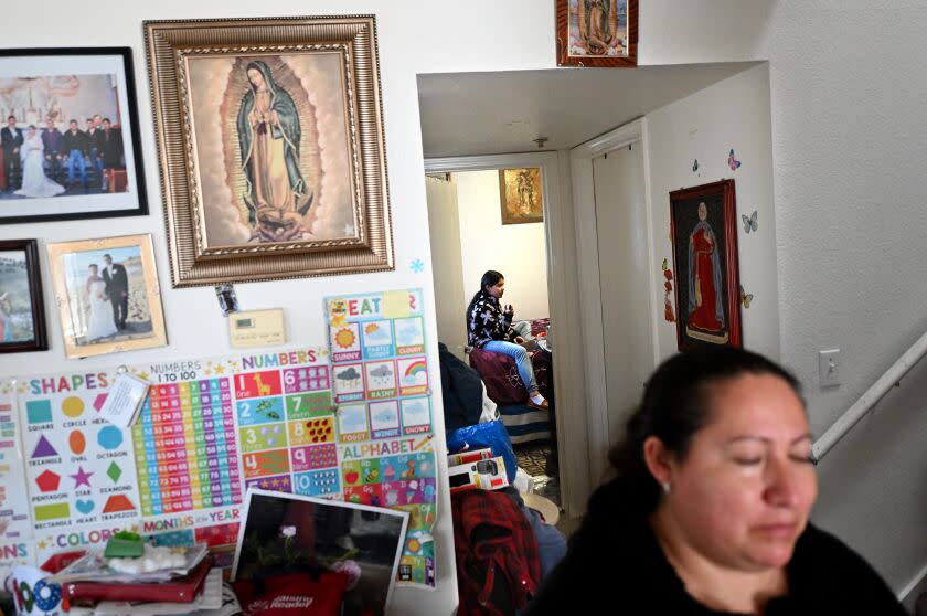 Half Moon Bay, California February 6, 2023- Farm worker Rocio Avila looks on as her daughter Crystal, 11, sits in her room that she shares with two siblings and er parents at a home in Half Moon Bay. (Wally Skalij/(Los Angeles Times)