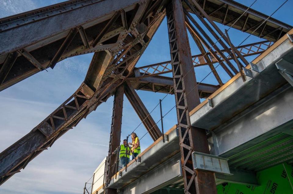 Guests stand on a balcony overlooking the Rock Island Bridge walkway as they tour the bridge and its new construction additions on Wednesday, April 17, 2024, in Kansas City, Kansas.
