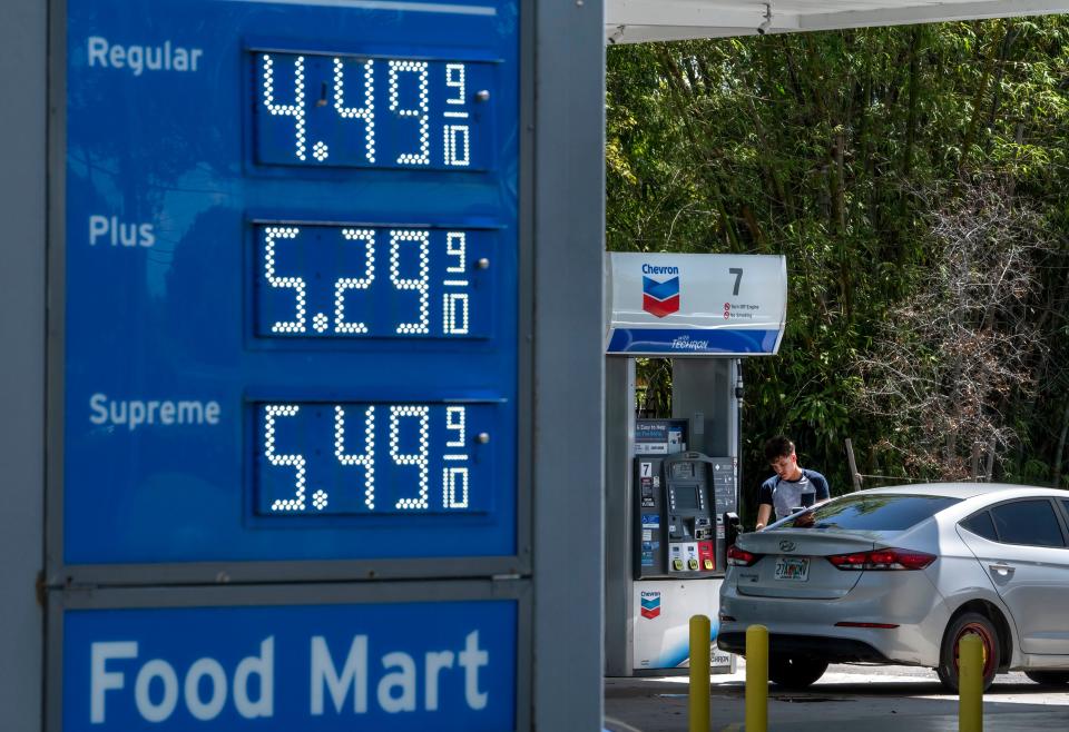 A customer pumps gas at a Chevron station Monday in West Palm Beach. Gas prices continue to drop around the state.