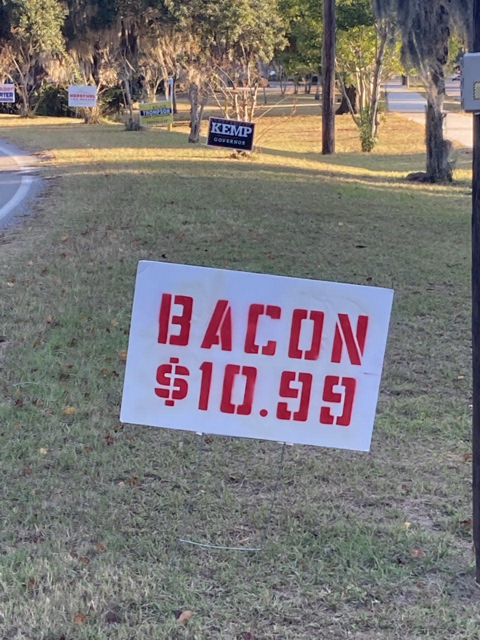 Signs that read simply "Bacon $10.99" are a reference to inflation in the grocery store and a condemnation of the political party in power, the Democrats.