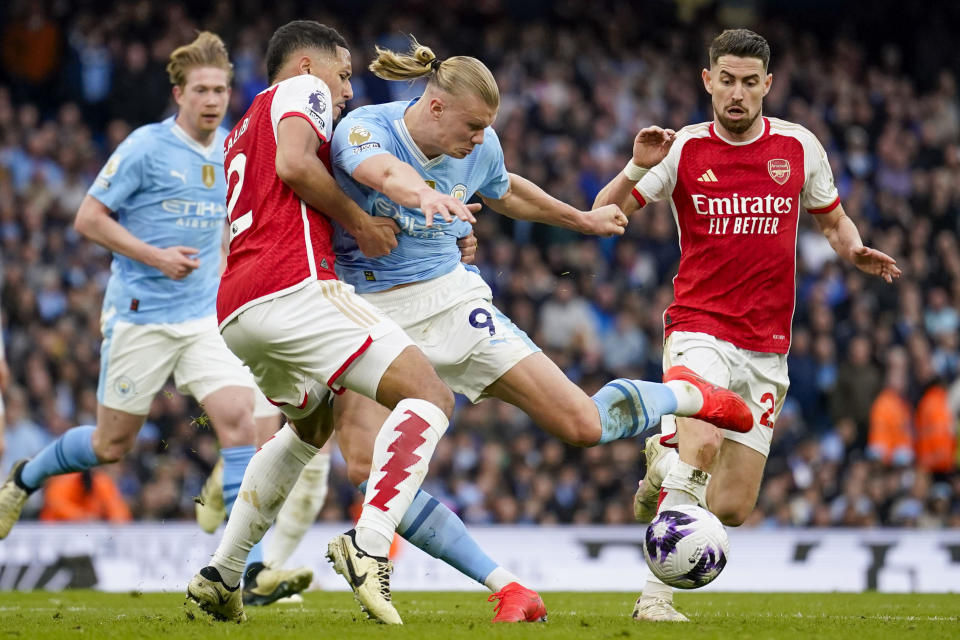 FILE - Manchester City's Erling Haaland, center right, duels for the ball with Arsenal's William Saliba during the English Premier League soccer match between Manchester City and Arsenal at the Etihad stadium in Manchester, England, Sunday, March 31, 2024. A fourth-straight Premier League title for Manchester City marks an unprecedented period of dominance by one team in English soccer. (AP Photo/Dave Thompson, File)