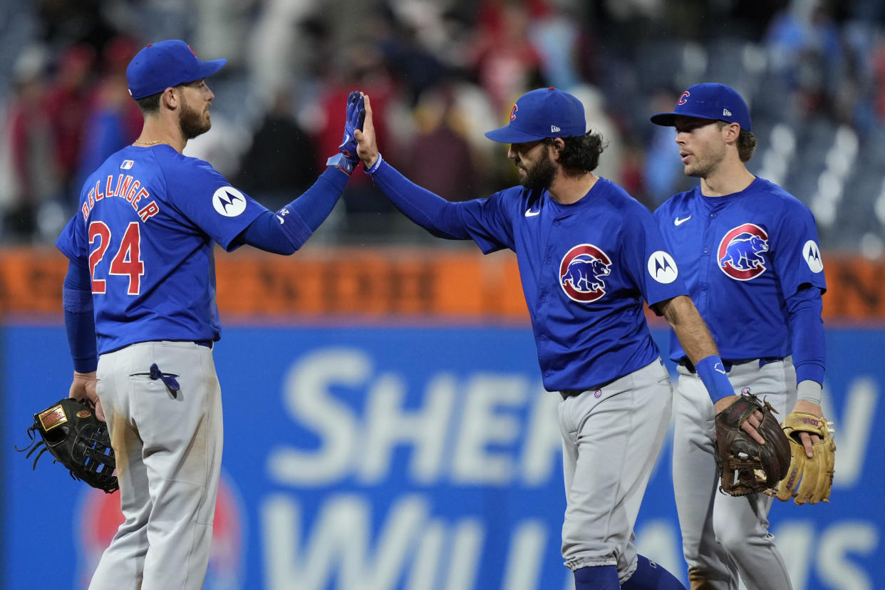 Chicago Cubs' Cody Bellinger, from left, Dansby Swanson and Nico Hoerner celebrate after the Cubs won a baseball game against the Philadelphia Phillies, Tuesday, Sept. 24, 2024, in Philadelphia. (AP Photo/Matt Slocum)