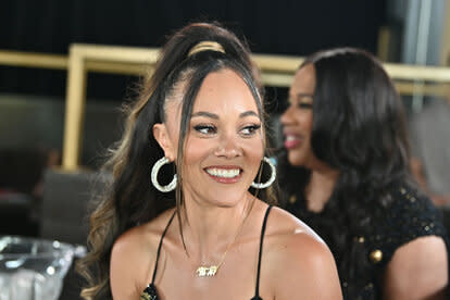 Ashley Darby smiling at an event with a high ponytail.