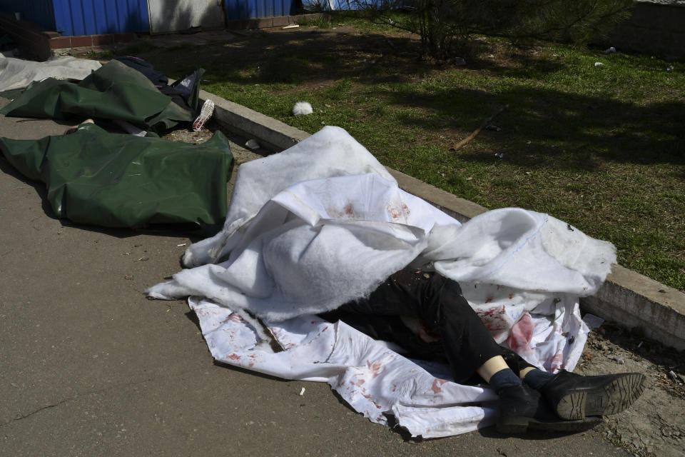 Bodies lay covered after Russian shelling at the railway station in Kramatorsk, Ukraine, Friday, April 8, 2022. Hours after warning that Ukraine's forces already had found worse scenes of brutality in a settlement north of Kyiv, President Volodymyr Zelenskyy said that “thousands” of people were at the station in Kramatorsk, a city in the eastern Donetsk region, when it was hit by a missile. (AP Photo/Andriy Andriyenko)