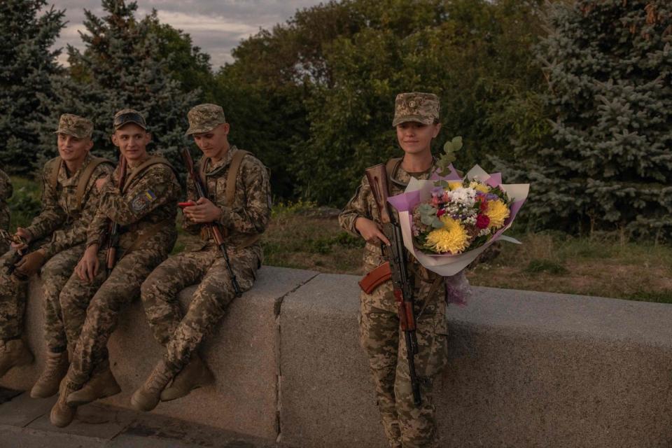 A Ukrainian female cadet stands with flowers after a ceremony for taking the military oath at The National Museum of the History of Ukraine in the Second World War in Kyiv, on Sept. 8. (Photo by Roman PILIPEY / AFP) (Photo by ROMAN PILIPEY/AFP via Getty Images)