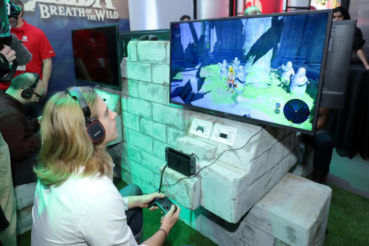 In this photo provided by Nintendo of America, a guest enjoys playing The Legend of Zelda: Breath of the Wild on the groundbreaking new Nintendo Switch at a special preview event in New York (Getty Images for Nintendo of Ame)