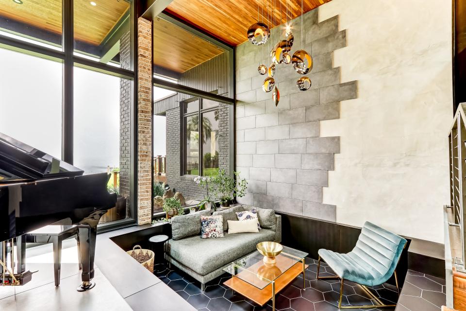 This conversation pit, with its feature wall and unique light fixture, was the first project Josh Lambo tackled for the renovation. It had been filled in by the previous owner.