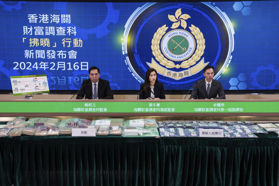 Head of Customs Financial Investigation Bureau Ip Tung-ching, center, Deputy Head Yeung Yuk-man, left, and Divisional Commander Yu Yiu-wing attend a press conference on a money laundering case in Hong Kong, Friday, Feb. 16, 2024.(AP Photo/Louise Delmotte)