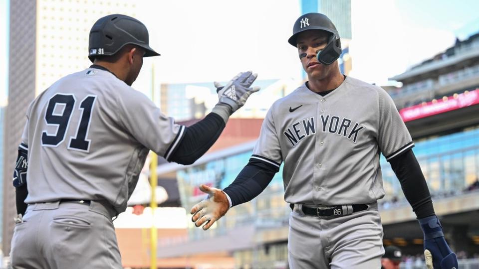 New York Yankees center fielder Aaron Judge (99) celebrates with second baseman Oswald Peraza (91) after scoring a run on a single by third baseman DJ LeMahieu during the first inning at Target Field.