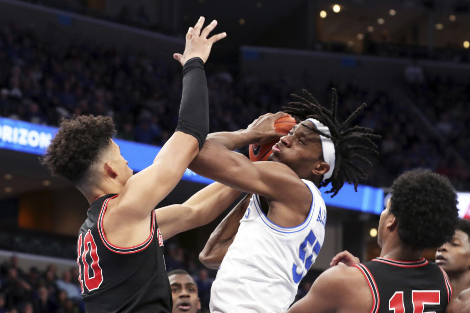 Memphis' forward Precious Achiuwa (55) grabs a rebound as Georgia forward Toumani Camara (10) defends in the second half of an NCAA college basketball game Saturday, Jan. 4, 2020, in Memphis, Tenn. (AP Photo/Karen Pulfer Focht)