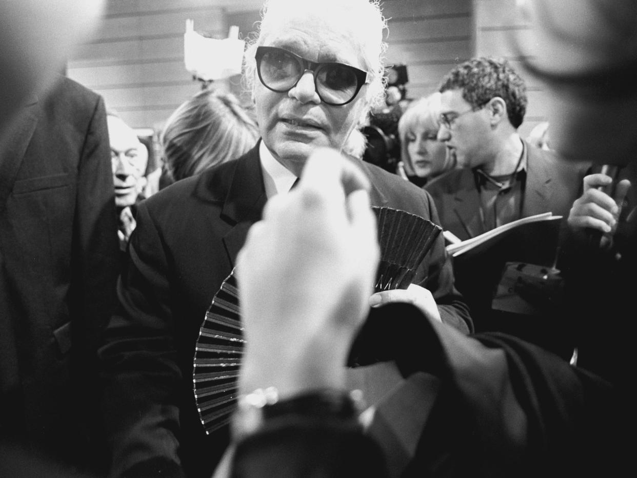 Black and white photo of Karl Lagerfeld in crowd in 1997