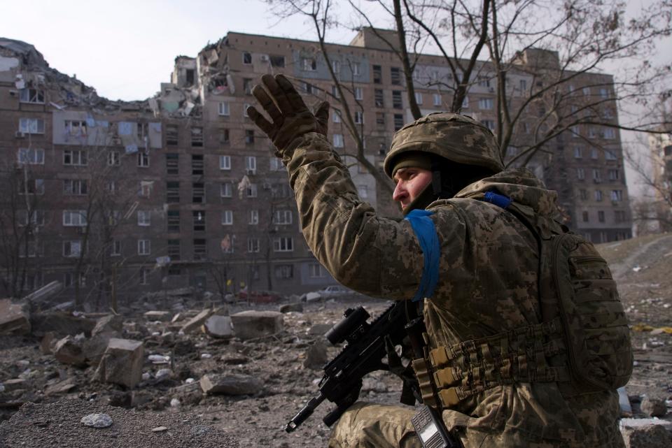 A Ukrainian serviceman guards his position in Mariupol (AP)