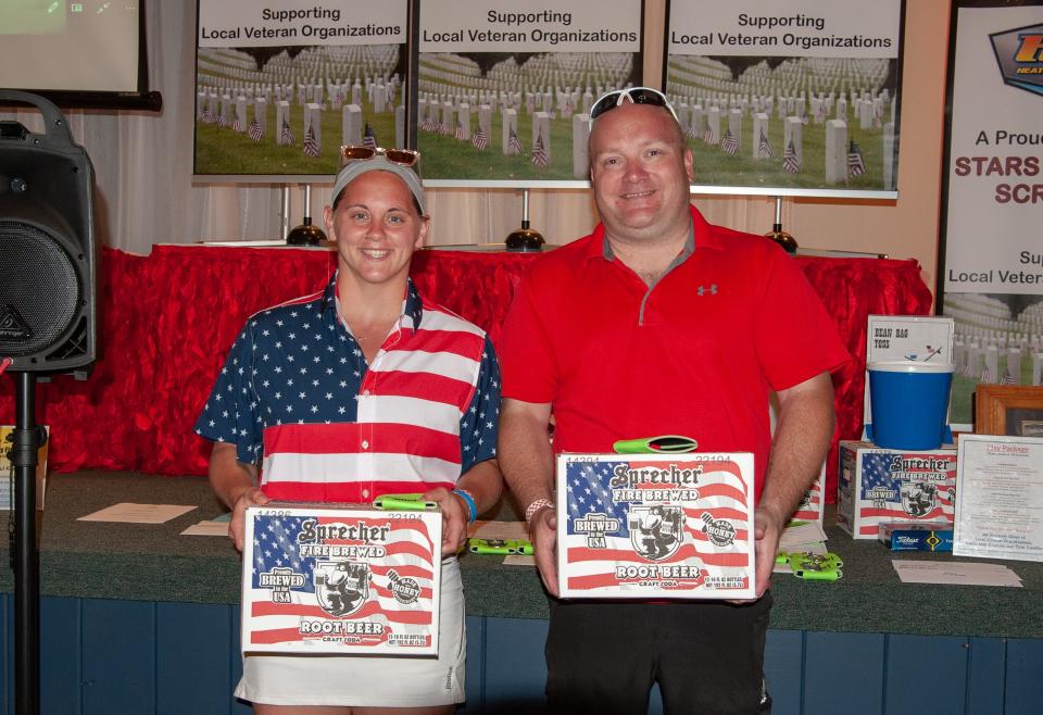 Sami Williams, left, and Ian Stawicki shared the prize of Sprecher Root Beer for the best hole of the Stars and Stripes Scramble thanks to their aces at The Golf Club at Camelot.