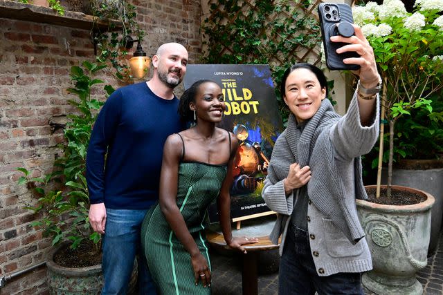 <p>Eugene Gologursky/Getty</p> Peter Brown, Lupita Nyong'o and Eva Chen