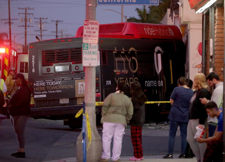 LONG BEACH, CALIF. - Long Beach police and fire department personnel investigate the scene of a bus crash on South Street in Long Beach, which resulted in injuries to 14 people on Thursday, Nov. 9, 2023. (Luis Sinco / Los Angeles Times)