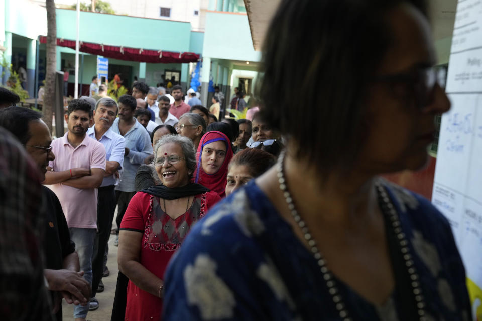 People line up to caste their votes at a polling station in Bengaluru, India, Wednesday, May 10, 2023. Thousands of people began voting Wednesday in a key southern Indian state where pre-poll projections have put the opposition Congress ahead of Prime Minister Narendra Modi's governing Hindu nationalist party. (AP Photo/Aijaz Rahi)