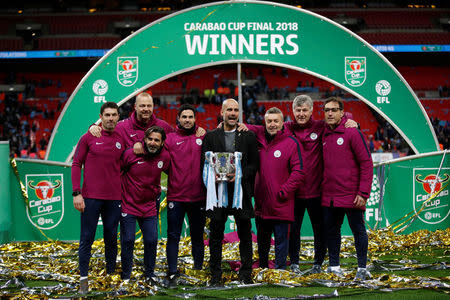 Soccer Football - Carabao Cup Final - Arsenal vs Manchester City - Wembley Stadium, London, Britain - February 25, 2018 Manchester City manager Pep Guardiola and his staff celebrate with the trophy after winning the Carabao Cup Action Images via Reuters/Carl Recine