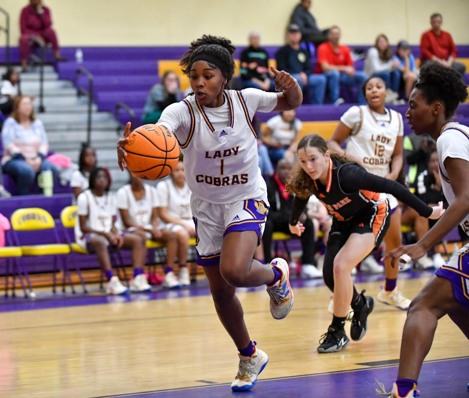 Fort Pierce Central's Harmon Randolph (1) goes for a loose ball in a girls high school basketball game against Lincoln Park Academy on Thursday, Jan. 11, 2024, in Fort Pierce.