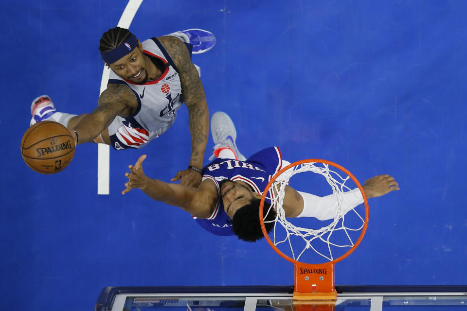 Washington Wizards' Bradley Beal, left, goes up for a shot against Philadelphia 76ers' Tobias Harris during the second half of Game 5 in a first-round NBA basketball playoff series, Wednesday, June 2, 2021, in Philadelphia. (AP Photo/Matt Slocum)