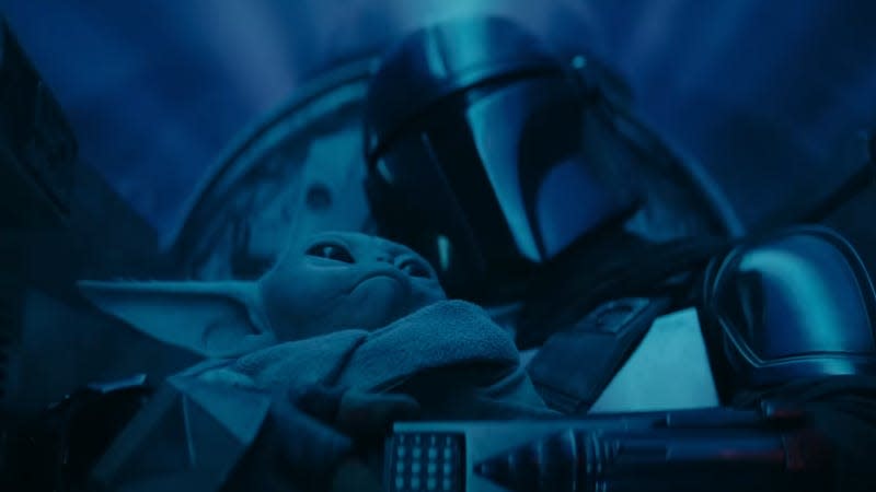 Din cuddles Grogu in the cramped cockpit of their N-1 Starfighter while in hyperspace.