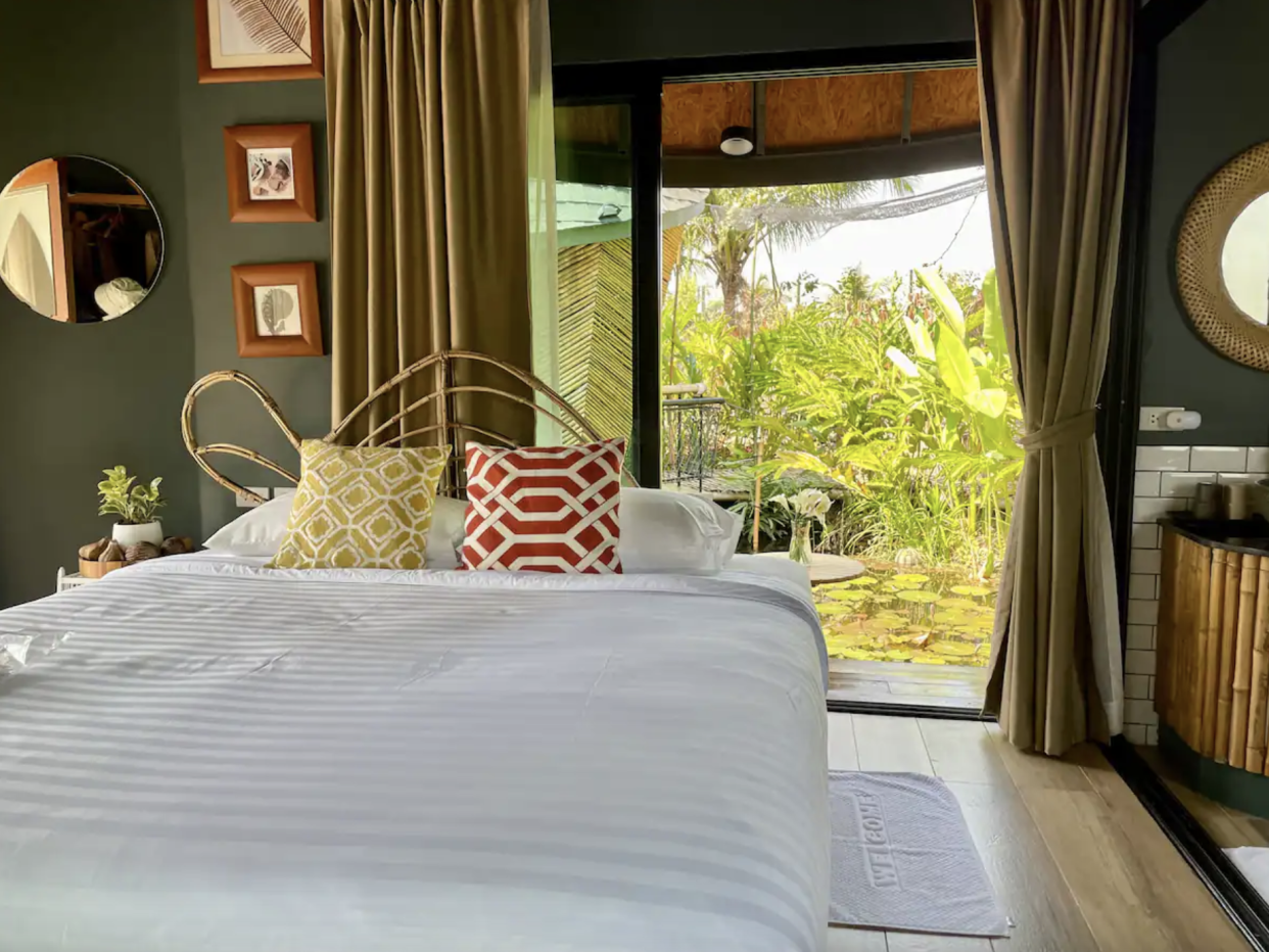 Houseboat Turtle Bay Villa Interior: bed with view of pond in background