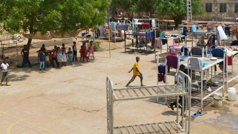 Displaced people who fled the ongoing violence by two rival Sudanese generals, gather in the courtyard of the university of Al-Jazira, transformed into a makeshift shelter, in al-Hasahisa south of Khartoum on July 8, 2023.