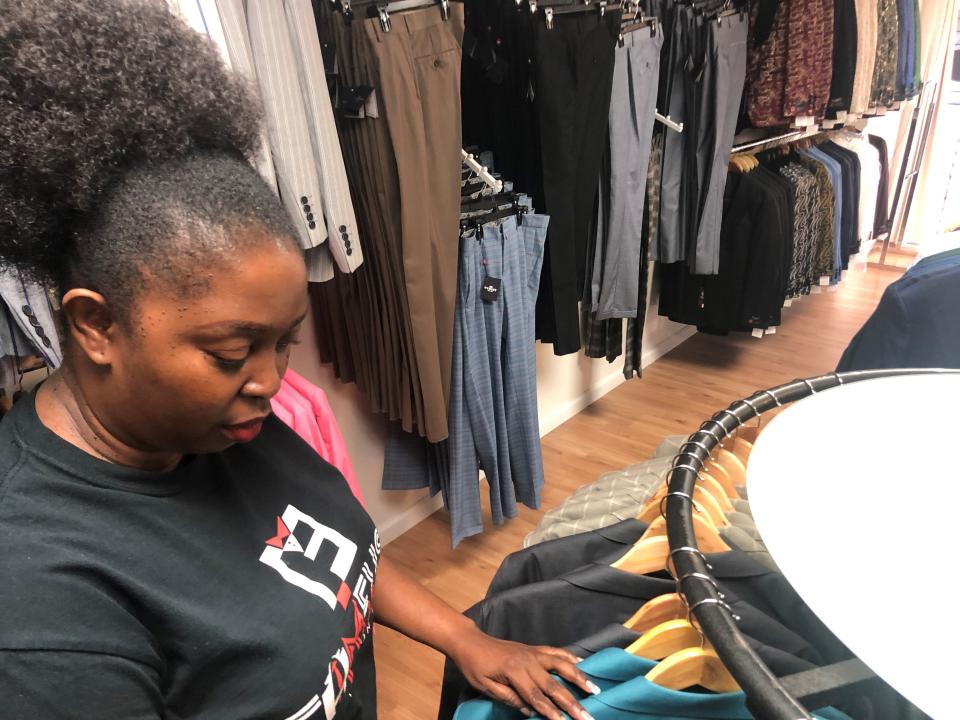 Kelly Okoro, a Nigerian immigrant, chose to open her men’s clothing shop in an aging shopping center in Riverdale rather than in a more upscale location in Atlanta because she felt the area needed a store like hers.