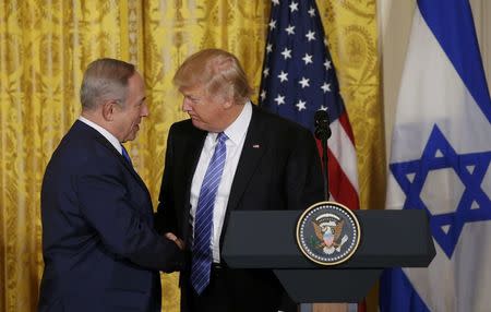 U.S. President Donald Trump (R) greets Israeli Prime Minister Benjamin Netanyahu at a joint news conference at the White House in Washington, U.S., February 15, 2017. REUTERS/Kevin Lamarque