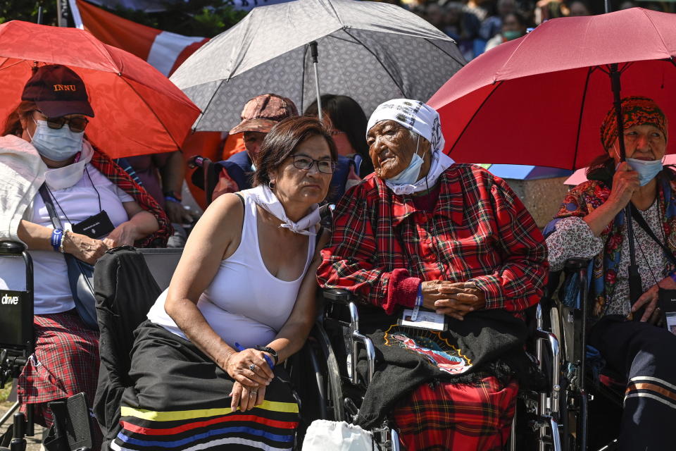 Spectators watch the holy mass celebrated by Pope Francis outside the Basilica of Sainte-Anne de Beaupre east of Quebec City, Thursday, July 28, 2022. (Bernard Brault /The Canadian Press via AP)