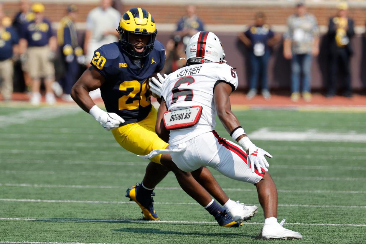 Michigan Wolverines running back Kalel Mullings runs the ball against Arkansas State Red Wolves safety Dontay Joyner during the first half at Michigan Stadium in Ann Arbor on Saturday, Sept. 14, 2024.