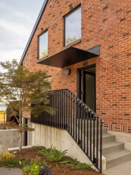 On the home’s east facade, a steel canopy protects the reoriented entry.