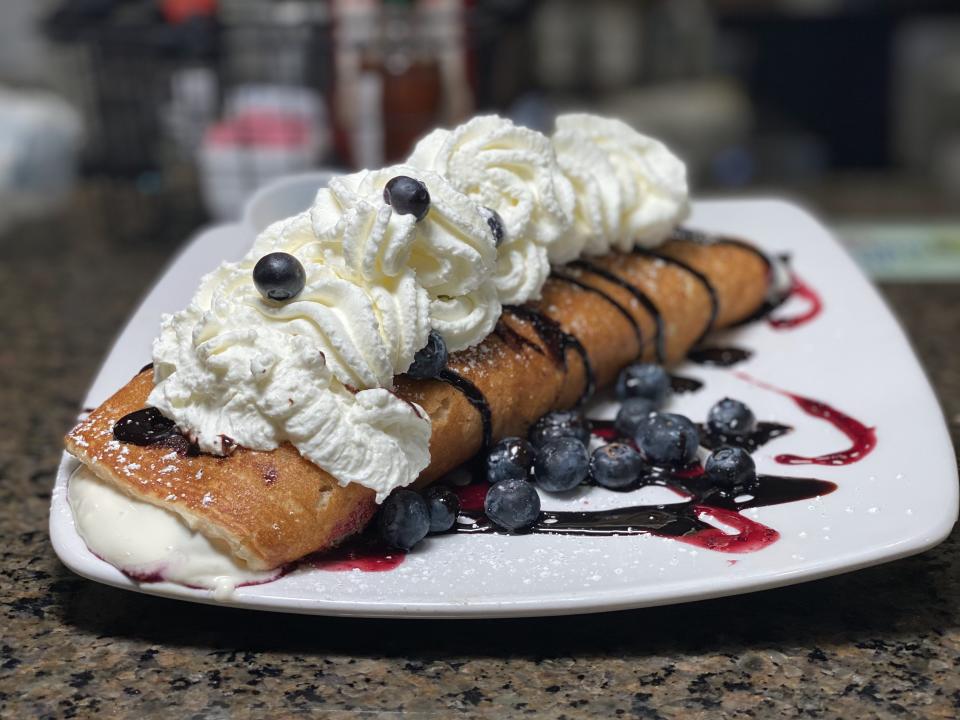 Berry Fresh Café's dark chocolate blueberry cheesecake roll-up is an oversized pancake that's stuffed with berries and cheesecake cream.