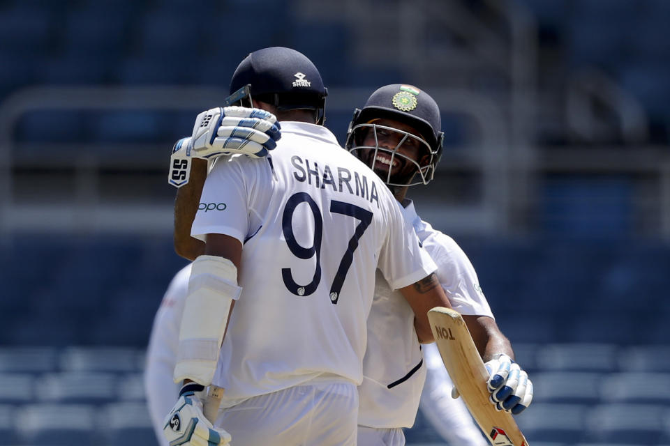 India's Ishant Sharma celebrates with teammate Hanuma Vihari scoring a half century against West Indies during day two of the second Test cricket match at Sabina Park cricket ground in Kingston, Jamaica Saturday, Aug. 31, 2019. (AP Photo/Ricardo Mazalan)