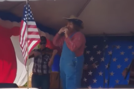A singer, allegedly comedian Sacha Baron Cohen in disguise, performs an offensive song at a right-wing event in Washington: YouTube/screengrab