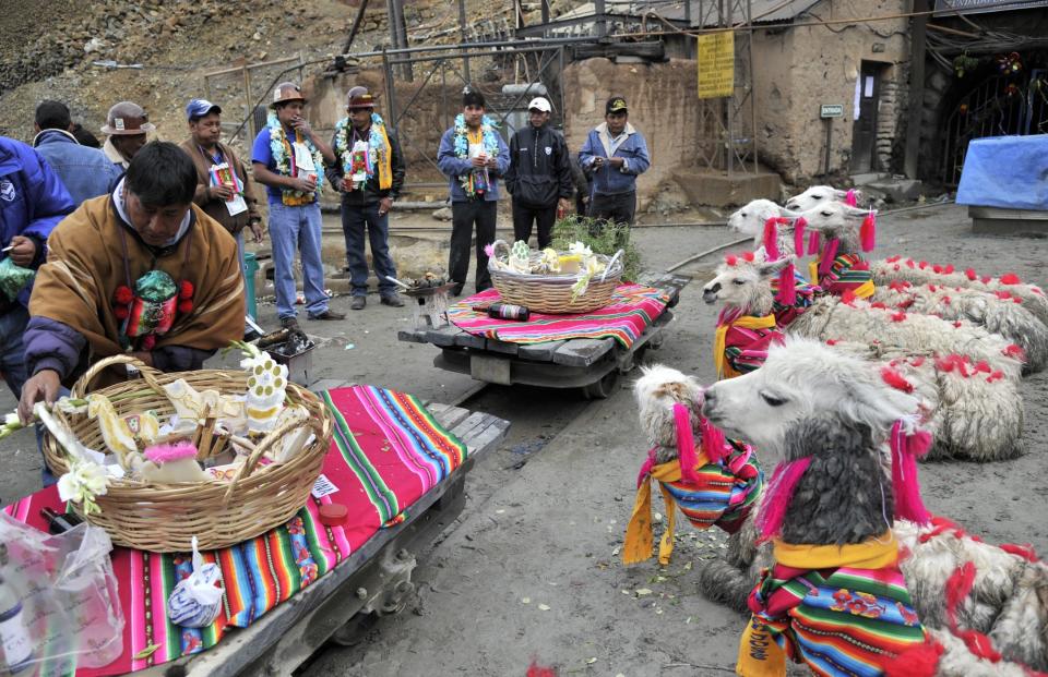 Bolivian miners take part in a 'wilancha' (sacrifice of animals) ritual to the Pachamama (Mother Earth) outside the Hitos Nueva San Jose tin mine in the outskirts of Oruro, Bolivia, on February 8, 2013 during the miners carnival.  AFP PHOTO/Aizar Raldes        (Photo credit should read AIZAR RALDES/AFP/Getty Images)