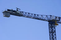 Banners for the Seattle Kraken NHL hockey team and the Mortenson Construction Company, are shown on a construction crane as work continues on the Climate Pledge Arena, Tuesday, Sept. 1, 2020, in Seattle, the home of the Seattle Kraken NHL hockey team. Sometime in the late summer or early fall of 2021, the Kraken will open the new facility -- at a cost that will likely total $1 billion by the time it's done -- and become the NHL's 32nd franchise. (AP Photo/Ted S. Warren)