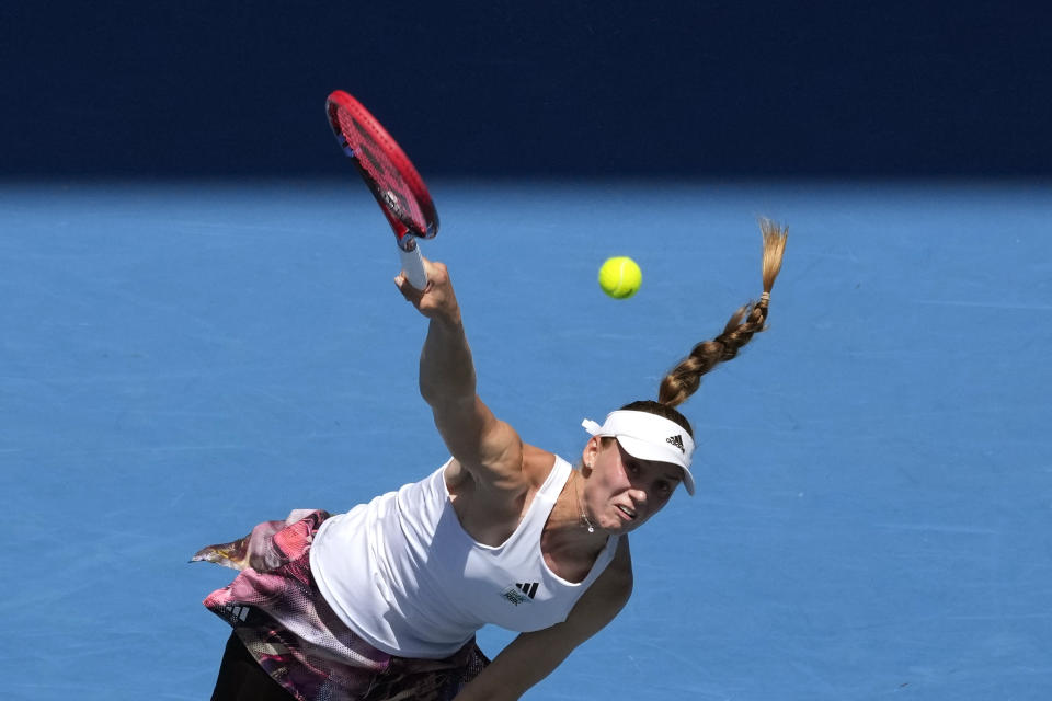 Elena Rybakina of Kazakhstan serves to Iga Swiatek of Poland during their fourth round match at the Australian Open tennis championship in Melbourne, Australia, Sunday, Jan. 22, 2023. (AP Photo/Aaron Favila)