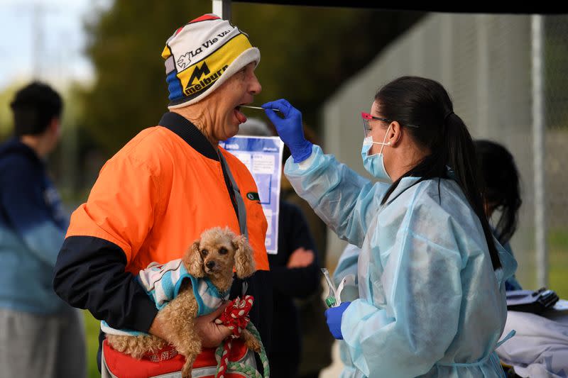 A medical professional administers a COVID-19 test to a member of the public in Melbourne