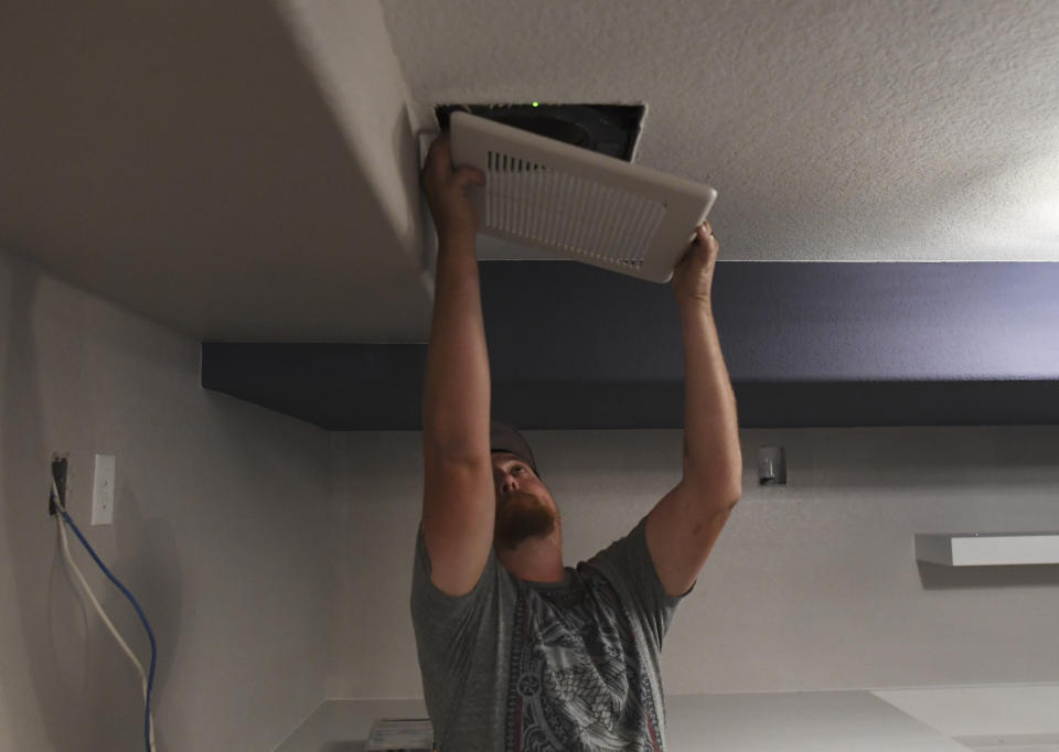 ENGLEWOOD, CO - AUGUST 30: Brandon McNitt, of McNiitt Brothers Heating, puts in a fan cover while working on a basement remodel on August 30, 2018 in Englewood, Colorado. (Photo by RJ Sangosti/The Denver Post via Getty Images)