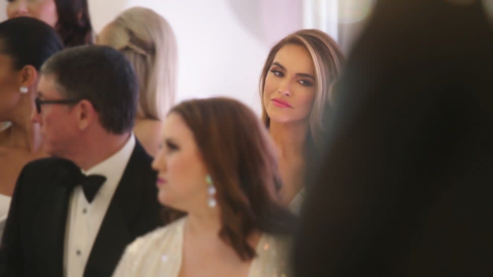 Chrishell Stause sits in the crowd of Christine Quinn's wedding on 'Selling Sunset.'