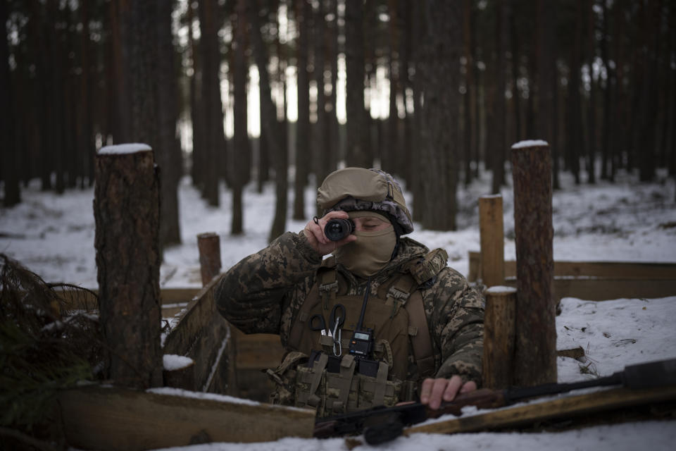 A Ukrainian serviceman looks out from a position close to the border with Belarus, Ukraine, Wednesday, Feb. 1, 2023. Reconnaissance drones fly several times a day from Ukrainian positions across the border into Belarus, a close Russian ally, scouring for signs of trouble on the other side. Ukrainian units are monitoring the 1,000-kilometer (650-mile) frontier of marsh and woodland for a possible surprise offensive from the north, a repeat of the unsuccessful Russian thrust towards Kyiv at the start of the war nearly a year ago. (AP Photo/Daniel Cole)