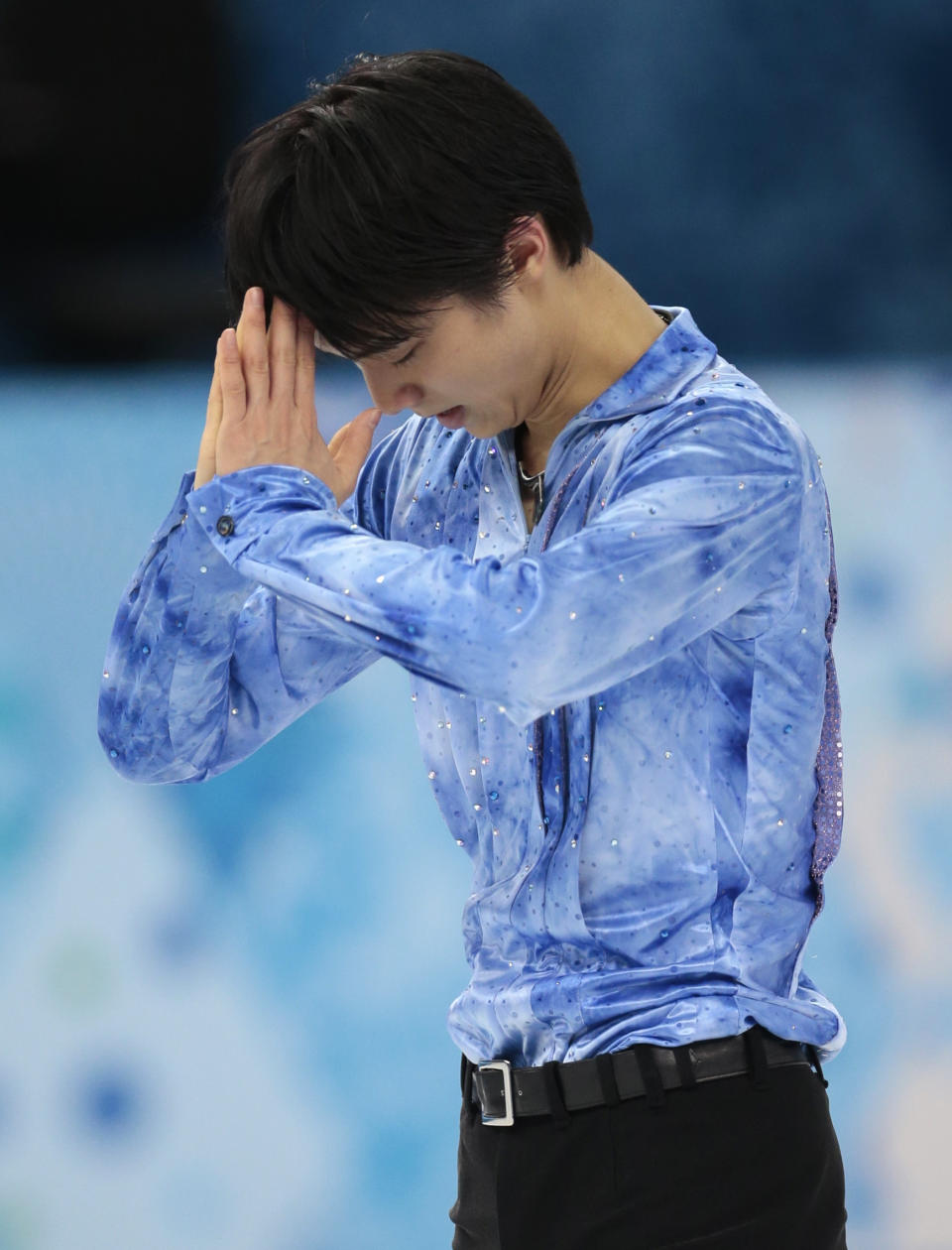 Yuzuru Hanyu of Japan gestures after competing in the men's team short program figure skating competition at the Iceberg Skating Palace during the 2014 Winter Olympics, Thursday, Feb. 6, 2014, in Sochi, Russia. (AP Photo/Ivan Sekretarev)