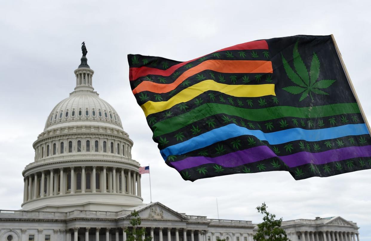 <span class="caption">Activists wave flags in front of the U.S. Capitol to demand that Congress pass cannabis reform legislation on Oct. 8, 2019.</span> <span class="attribution"><a class="link " href="https://www.gettyimages.com/detail/news-photo/activists-from-the-dc-marijuana-justice-wave-flags-during-a-news-photo/1174516103?adppopup=true" rel="nofollow noopener" target="_blank" data-ylk="slk:Olivier Douliery/AFP via Getty Images;elm:context_link;itc:0;sec:content-canvas">Olivier Douliery/AFP via Getty Images</a></span>