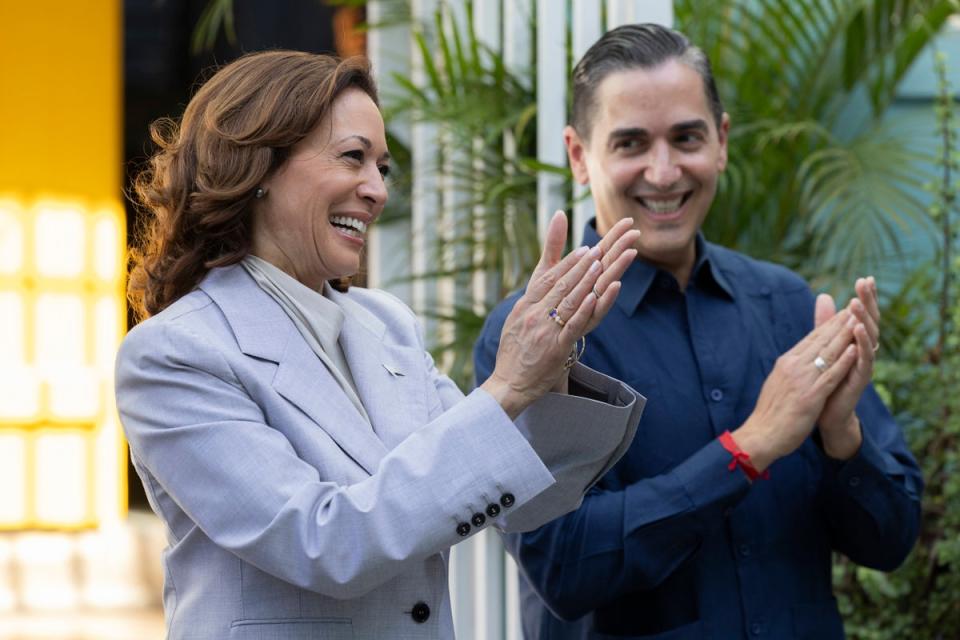 Vice President Kamala Harris, left, and Frankie Miranda, Hispanic Federation president, applaud, during a visit, in San Juan, Puerto Rico (AP)