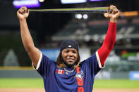 FILE - American League's Vladimir Guerrero Jr., of the Toronto Blue Jays, holds the MVP trophy after the MLB All-Star baseball game, Tuesday, July 13, 2021, in Denver. In all, more than two dozen major league offspring are on AL or NL rosters this year. The Blue Jays alone have three, including the sons of Hall of Famers Craig Biggio (Cavan) and Vladimir Guerrero (Vlad Jr.), along with Bo Bichette, whose father, Dante, was a four-time All-Star with the Rockies. (AP Photo/Jack Dempsey, File)