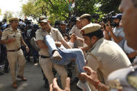 A supporter of opposition Congress party is detained by police while protesting against their leader Rahul Gandhi's expulsion from Parliament in New Delhi, India, Monday, March 27, 2023. Gandhi was expelled from Parliament a day after a court convicted him of defamation and sentenced him to two years in prison for mocking the surname Modi in an election speech. (AP Photo/Deepanshu Aggarwal)