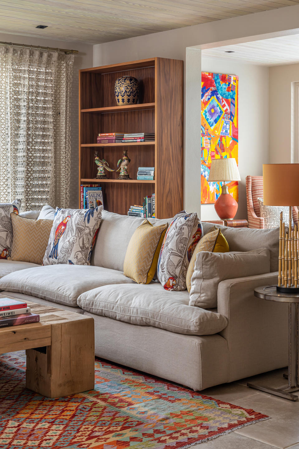 living room with parrot patterned cushions and decorative rug