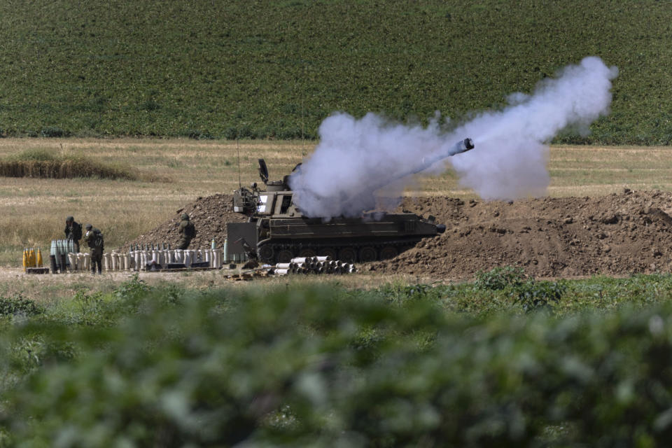An Israeli artillery unit fires toward targets in Gaza Strip, at the Israeli Gaza border, Tuesday, May 18, 2021. (AP Photo/Tsafrir Abayov)