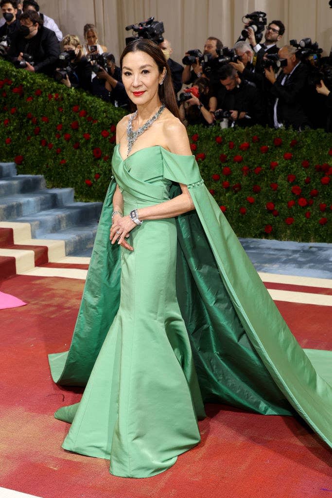 Michelle Yeoh in an off-the-shoulder gown with a train