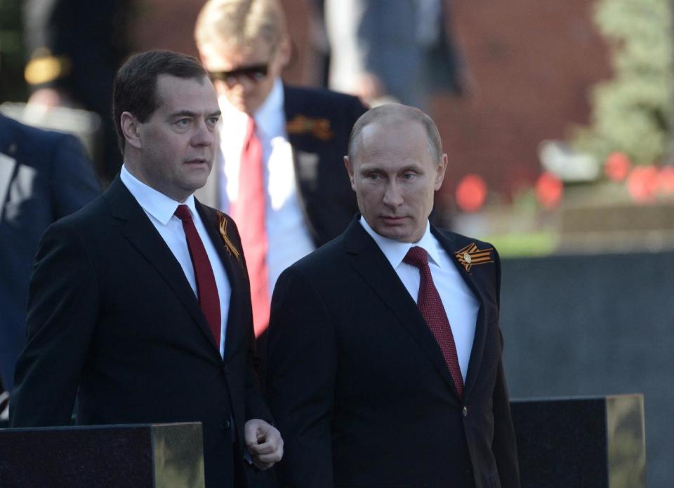 Russian President Vladimir Putin, right, and Prime Minister Dmitry Medvedev arrive to attend a Victory Day parade, which commemorates the 1945 defeat of Nazi Germany, in Moscow, Russia, Friday, May 9, 2014. Russia marked the Victory Day on May 9 holding a military parade at Red Square in Moscow. (AP Photo/RIA-Novosti, Alexei Nikolsky, Presidential Press Service)